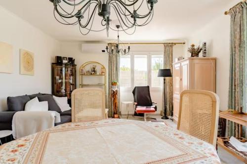 a living room with a bed and a couch at Villa Echauguette, Chambre et toilette privee Maison partagee avec la proprietaire in Six-Fours-les-Plages
