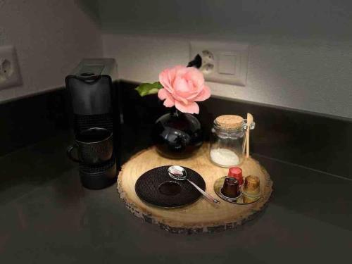 a vase with a pink flower on a table at Casetta ticinese nel nucleo in Minusio