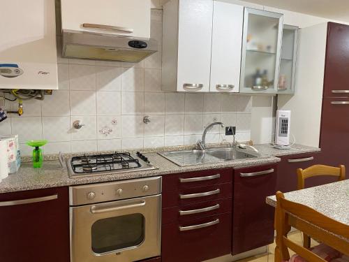 a kitchen with a sink and a stove at PRATE48 in Bologna
