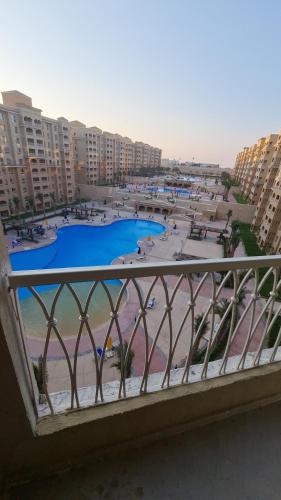 a view of a beach from a balcony with buildings at استوديو فندقي مكيف وفيو رائع in Borg El Arab