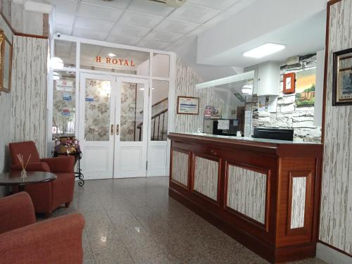 a lobby of a hair salon with a reception desk at Hotel Royal in Ronda