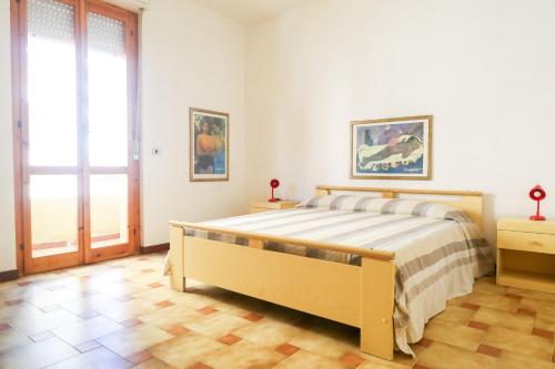 Un pat sau paturi într-o cameră la Alghero- Lungomare Via Lido Cozy Flat W/Parking!