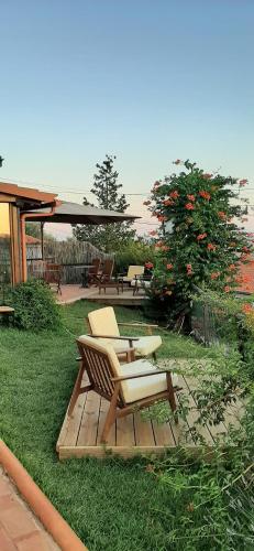 a patio with two chairs and a table at Casal da Serra in Penha Garcia