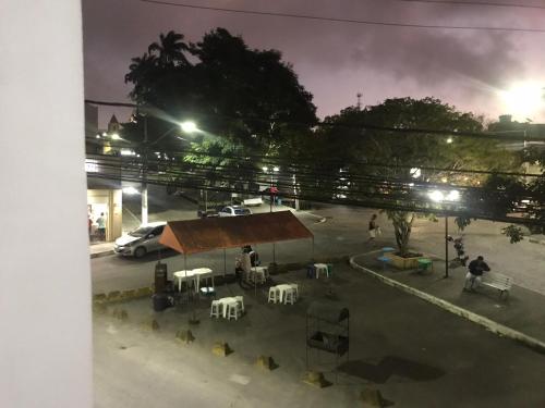 a restaurant with tables and chairs at night at Apartamento Boa Vista in Garanhuns