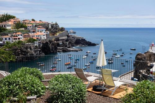 a view of a harbor with boats in the water at Casa Mar Adentro in Câmara de Lobos