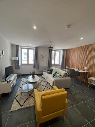 a living room with a couch and a yellow chair at Le Cosy in Crest