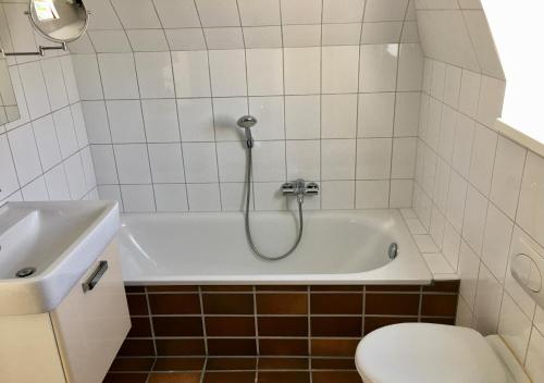 a bathroom with a tub and a toilet and a sink at Ostseenahes Traumhaus am Kiel-Kanal in Schleswig-Holstein - Zum Ostseestrand in zehn Minuten in Altenholz