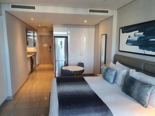 una habitación de hotel con una cama y una mesa en Pearls Full Sea View Luxury Studio - Self Catering, en Durban