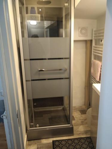 - une porte de douche en verre dans une petite salle de bains dans l'établissement gîte 4 chambres à Cognac, à Cognac