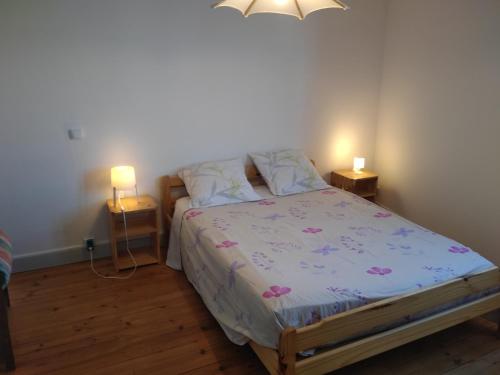 a bedroom with a bed and two night stands at gîte 4 chambres à Cognac in Cognac