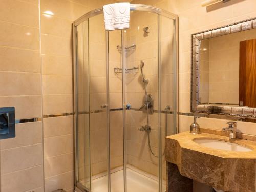a bathroom with a shower and a sink at Grand Karot Hotel in Yalova
