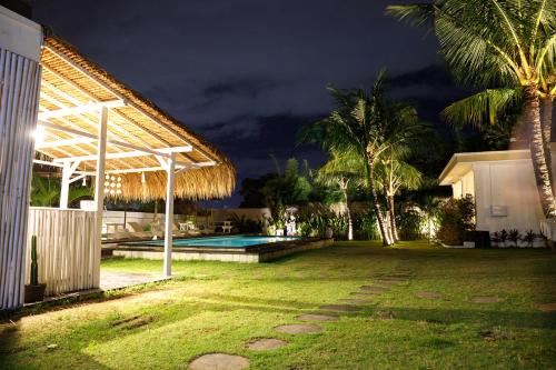 a backyard with a swimming pool at night at Bella Bali in Uluwatu