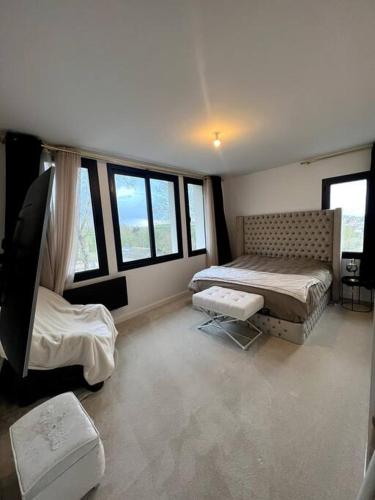 a bedroom with two beds and windows at Magnifique appart avec jaccuzi in Criel-sur-Mer