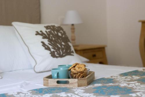 a teddy bear sitting in a wooden tray on a bed at Elios by PortofinoHomes in Portofino