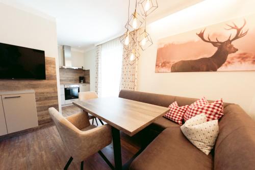 a living room with a couch and a table at Pension Gletscherblick in Fulpmes