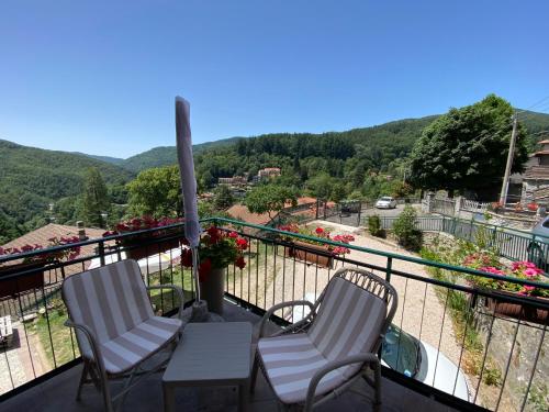 two chairs and a table on a balcony with a view at Da Mary in Badia Prataglia