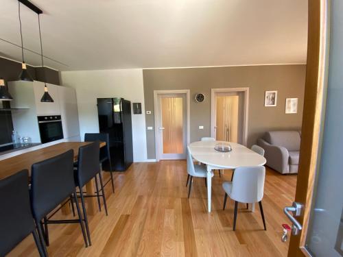 a living room and kitchen with a white table and chairs at Da Mary in Badia Prataglia