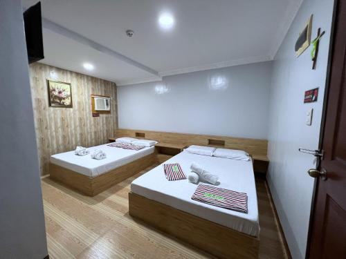 Postel nebo postele na pokoji v ubytování Ging-Ging Tourist Inn