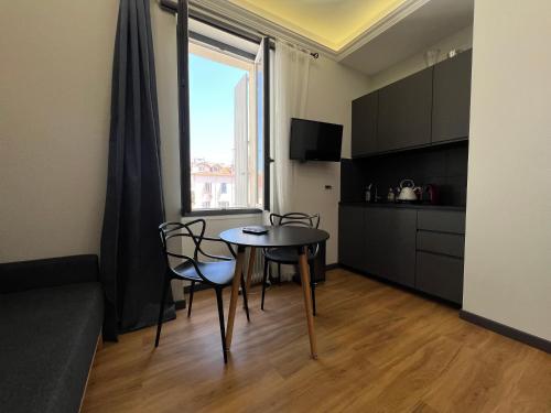 un soggiorno con tavolo e sedie e una cucina di Newly Renovated Suite in the Center of Cannes a Cannes