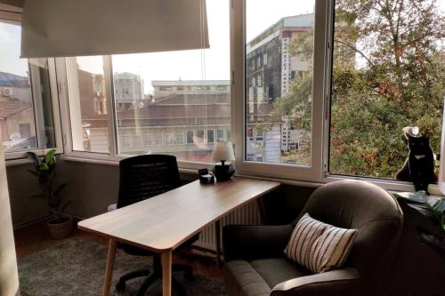 a room with a table and chairs and windows at Our flat is located in Beşiktaş Square. in Istanbul