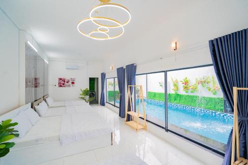 a living room with a large window and a pool at LP Villa 51 - Free Karaoke - Bida - Gần Bãi Sau in Vung Tau