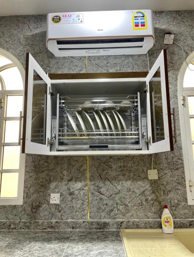 a toaster oven is hanging on a wall at Deluxe Apartment in Muscat