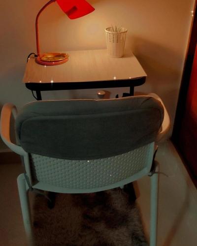 a desk with a chair with a lamp on it at Self-checking-Fast internet-Alexa-Smart-Tv-AC-Hot Water in Ensanche Ozama