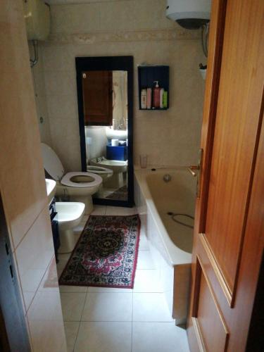 a bathroom with a tub and a toilet and a sink at Revibe Art Recidence in Scalea