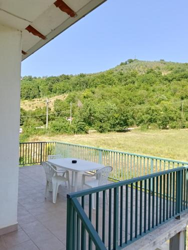 a patio with a table and chairs on a balcony at Casa Le Piane in Strettura