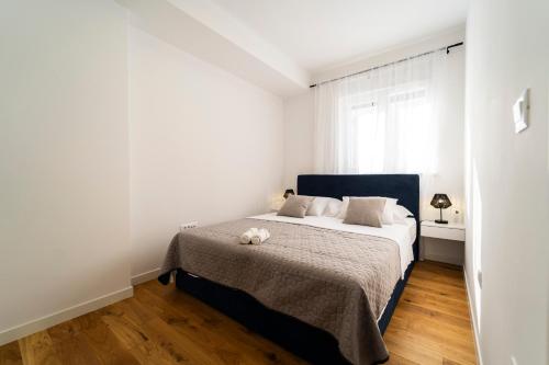 a bedroom with a bed with a teddy bear on it at Apartment Skyline Retreat in Zadar