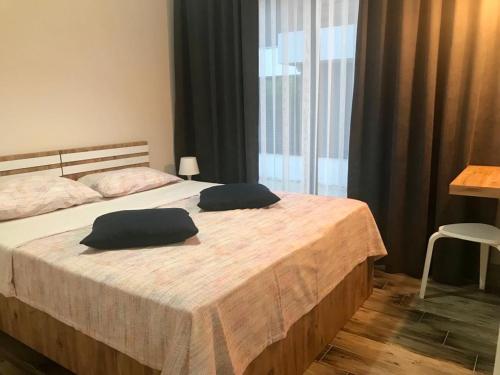 a bedroom with a bed with two pillows on it at Tanem Suit in Kemer