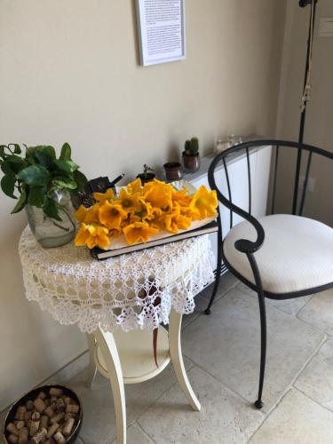 a table with a plate of yellow flowers on it at Agriturismo Il Molino in Quercianella