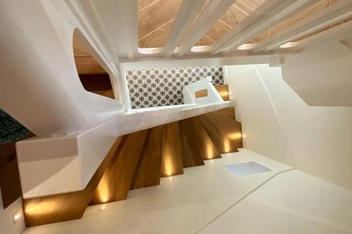 a staircase in a house with white walls and wooden floors at Lac's Lodge ¤ Maison coquette à 10min du lac in Annecy