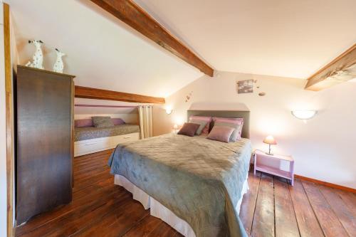 a bedroom with a large bed in a room at LE CLOS DU MOUY in La Souche