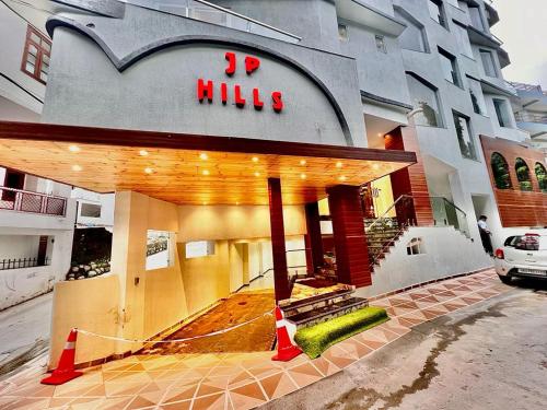 a building with a sign on the front of it at Hotel JP Hills Rishikesh in Rishīkesh