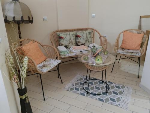 a living room with three chairs and a table at Central apartment in Gevgelija