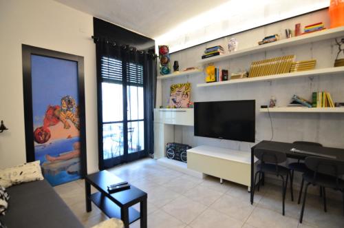 PollyHouse - Apartment في تورينو: غرفة معيشة مع أريكة وتلفزيون