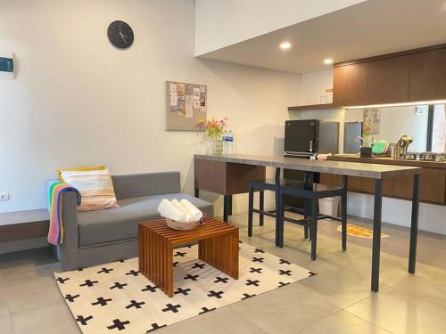 a kitchen and living room with a table and a couch at 2BR HOUSE Happystay at FREJA BSD lalerooms close to ICE BSD find us on ig lalerooms in Tangerang