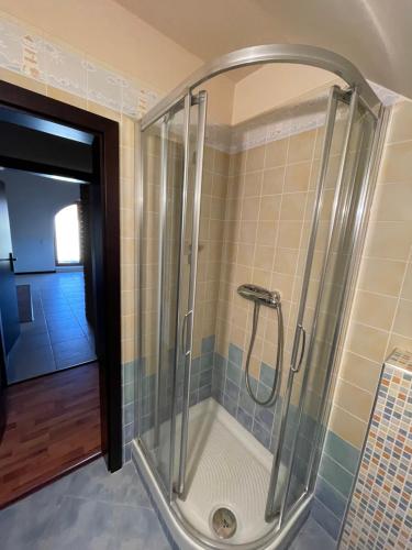 a shower with a glass door in a bathroom at RRR Apartmány 2 in Bojnice