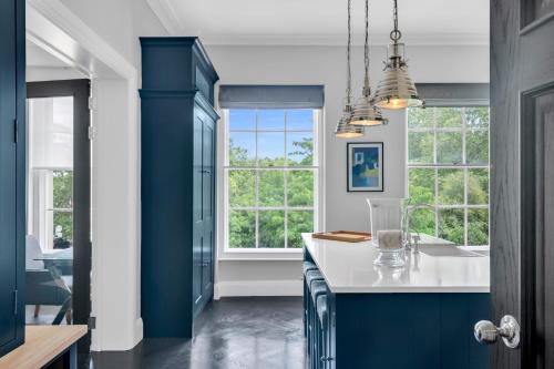 a kitchen with blue and white counters and windows at Be London - The Lincoln's Inn Residences in London