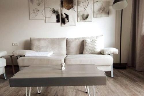 a living room with a couch and a coffee table at Ferienwohnung zur dicken Berta in Wolfegg