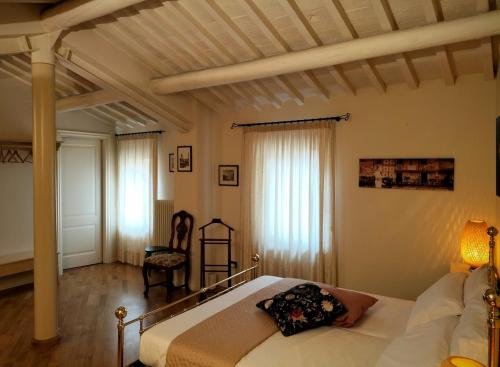 a bedroom with a bed and a chair at Catulliana in Verona