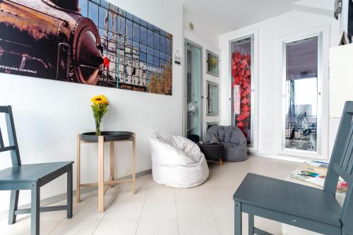 a living room with a vase of flowers on a table at New Pescara City b&b in Pescara