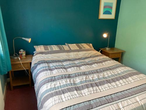 a bedroom with a bed and a desk with a lamp at Quiet flat with parking in Cleveleys