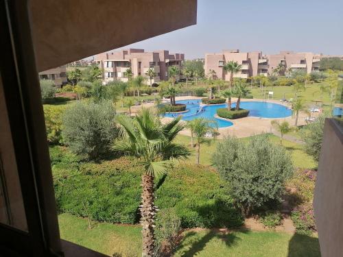 a view from a window of a resort with a pool at Appartement prestigia jade marrakech in Marrakesh