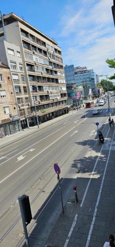 an empty street with parking meters on the side of the road at Villa 1927 in Belgrade
