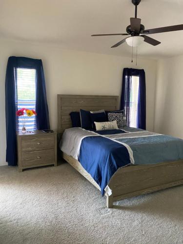 a bedroom with a bed and a ceiling fan at Marco Island Retreat- close to beach ! in Marco Island