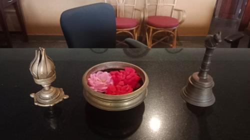 une table avec un bol de fleurs et deux lampes dans l'établissement Медицински Център Аюрведа, à Sveti Vlas