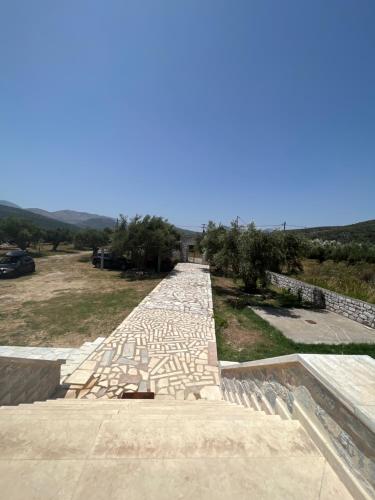 a stone pathway with trees on the side of a building at MANI Kamares Beach House in Gythio
