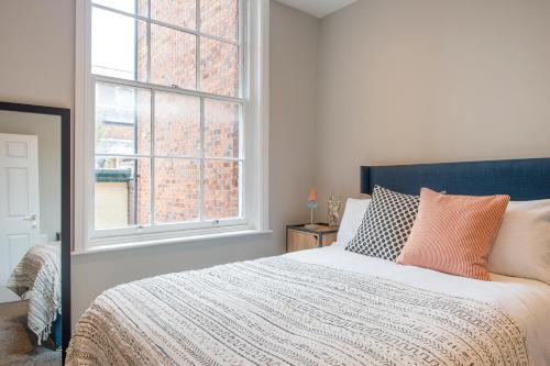 a bedroom with a large bed and a window at Preston Apartments in Preston